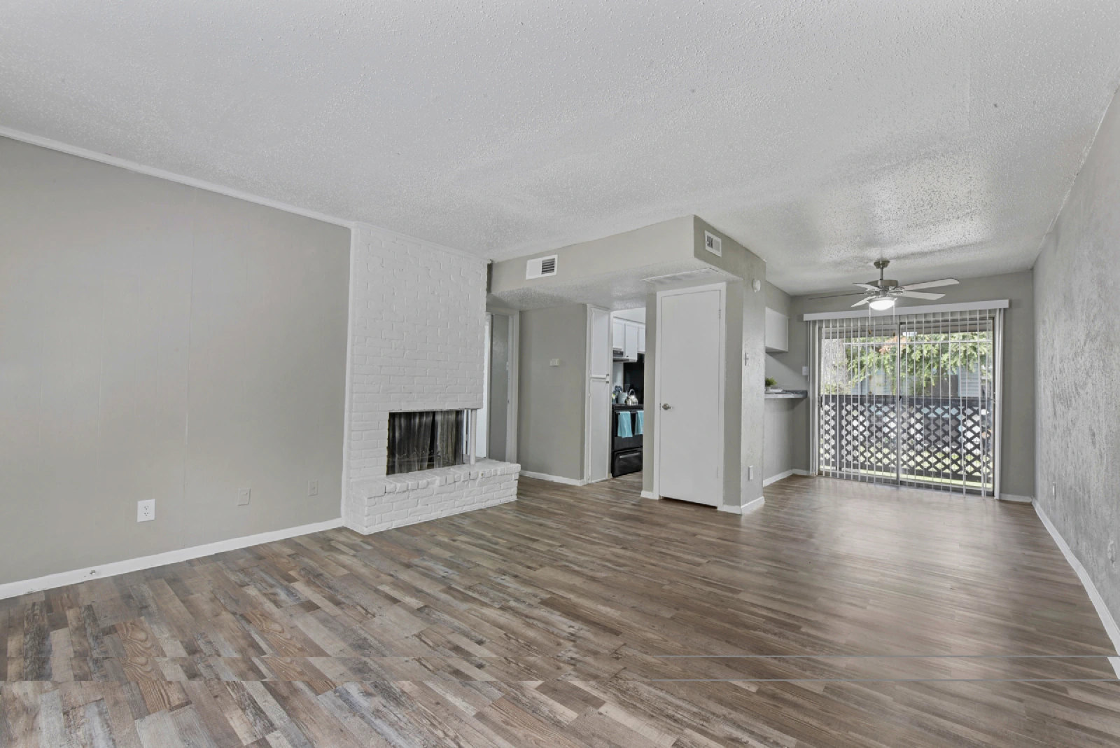 Unfurnished Villa Encanto living room with wood-look flooring and fireplace