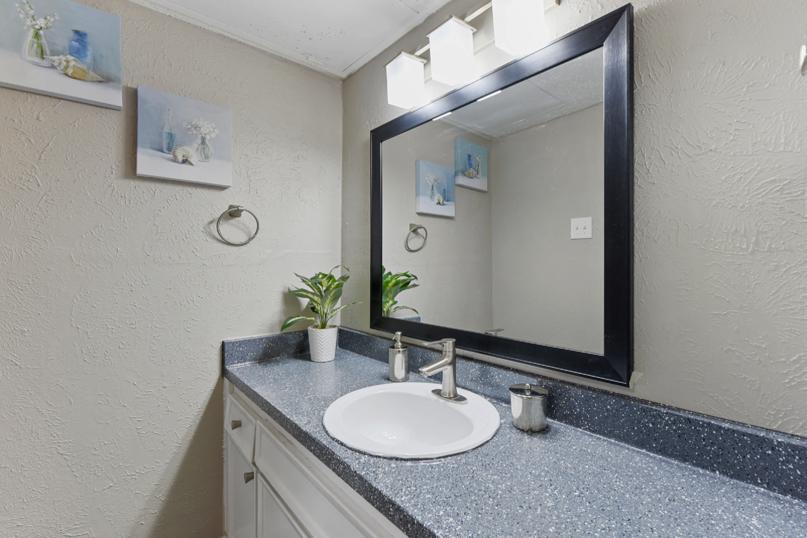 Villa Encanto bathroom vanity with a large framed mirror