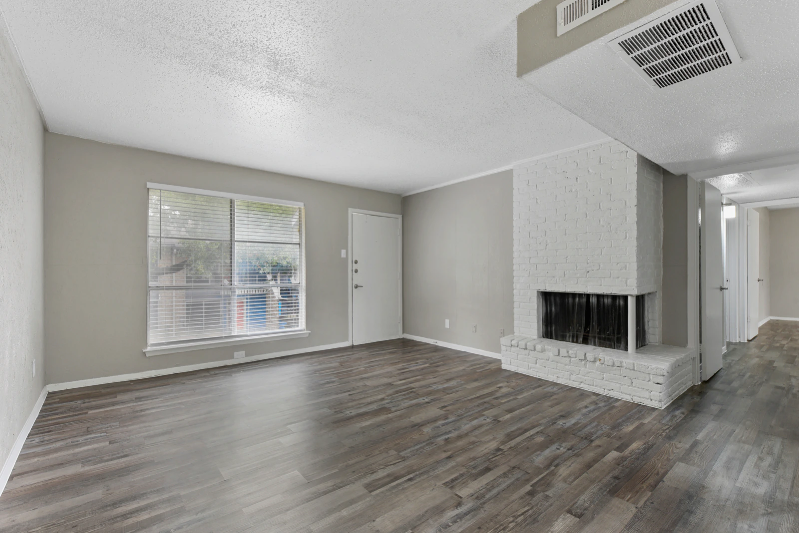 Unfurnished Villa Encanto living room with wood-look flooring and fireplace