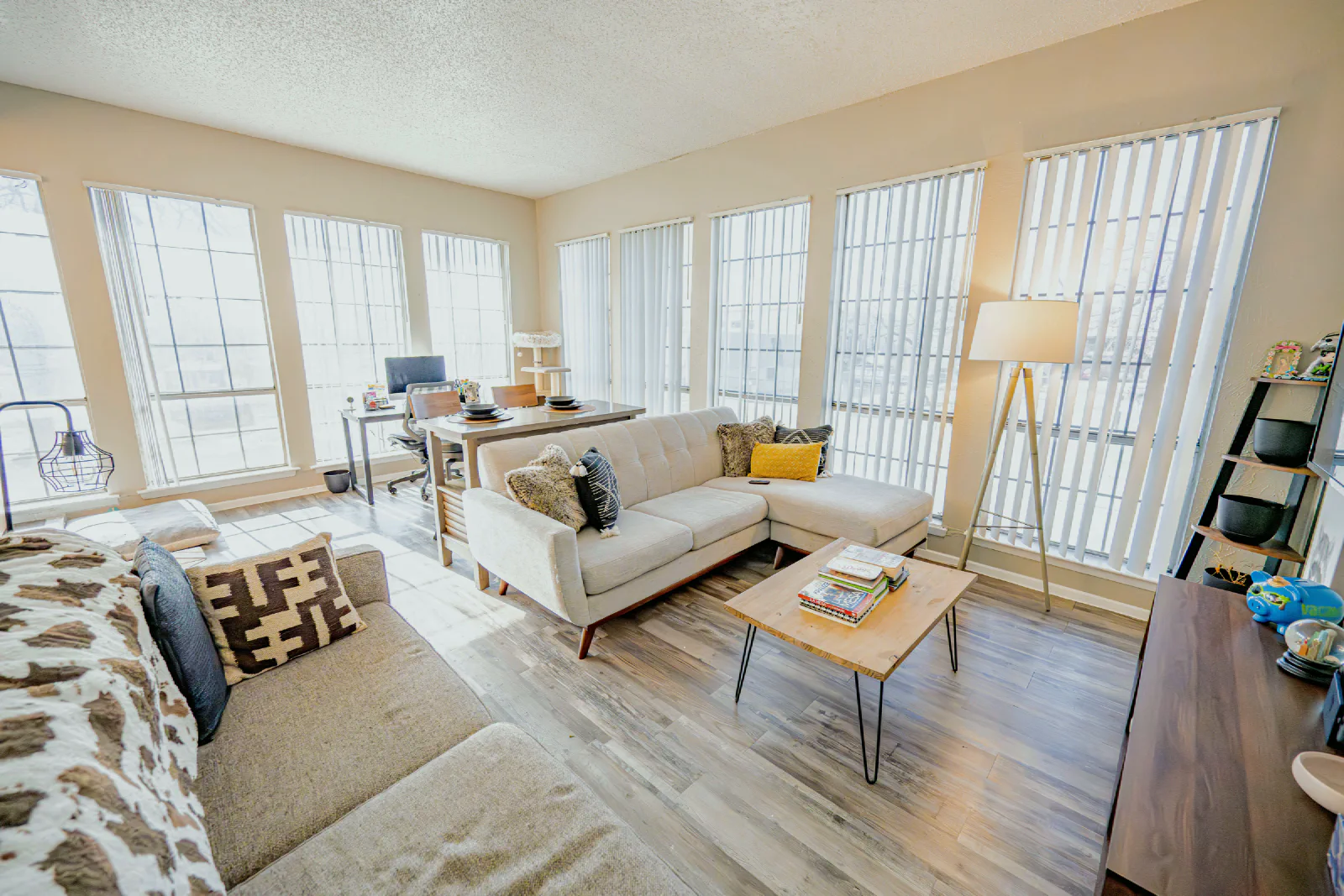 Furnished Villa Encanto living room with large windows and wood-look flooring