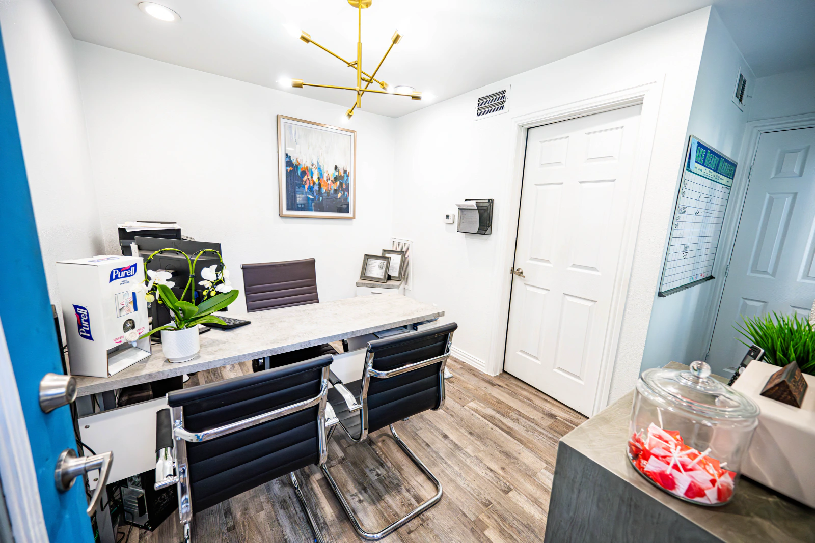 Villa Encanto leasing office with a desk and guest chairs
